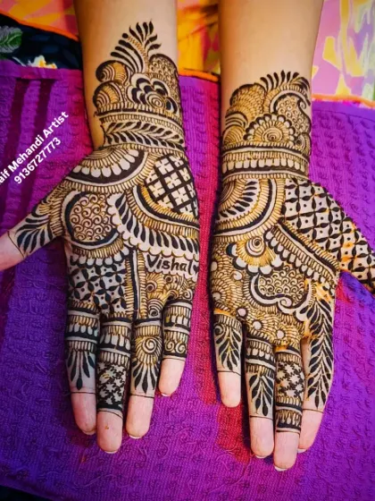 A top-down view of the personalized mehandi, highlighting the bold lines and intricate filler patterns.