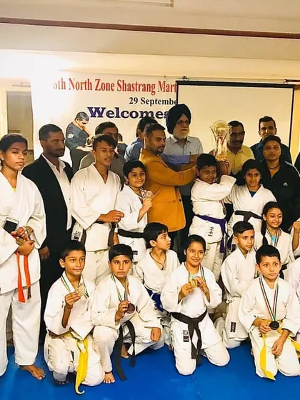 The team after a successful day at the North Zone Shastrang Martial Arts tournament. You can see students of all belt levels with their medals, showing that everyone has a chance to compete.