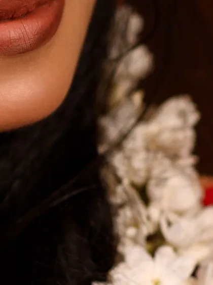 A detail shot of a warm, matte brown lip. This shade is versatile and works beautifully with traditional Indian outfits, providing a sophisticated finish.