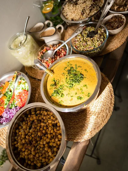 A close-up of the beautiful, nourishing food we serve. This spread includes a vibrant salad, creamy soup, and protein-rich chickpeas. Every meal is designed to be a complete, balanced, and delicious experience that supports your body's healing process.