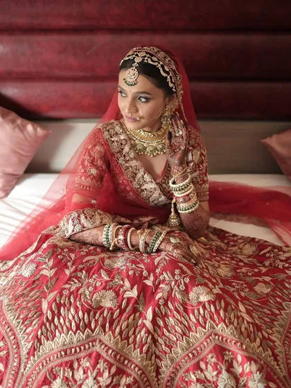 A regal bridal portrait. Her entire look, from the detailed lehenga to the dramatic makeup, exudes confidence and grace.