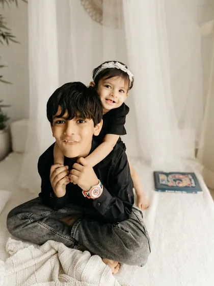The playful bond between siblings is one of my favorite things to photograph. A piggyback ride from big brother makes for a perfect, unposed memory.