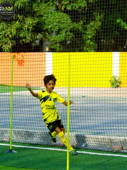 A player works on his agility and speed by weaving through training poles.