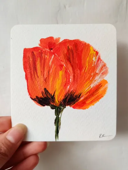 A small, expressive acrylic painting of a poppy. The bold colors and thick brushstrokes make it feel so vibrant and alive.