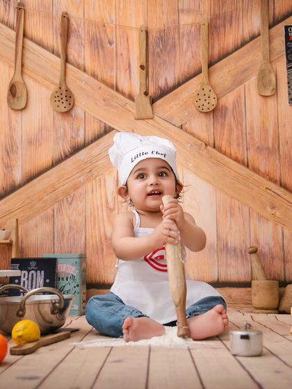 Little chef Vivaan is hard at work with his rolling pin, creating some kitchen magic in this fun and interactive setup.