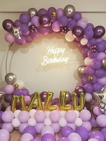 A gorgeous purple and silver chrome balloon arrangement on a ring frame, personalized with a name in gold foil letters.