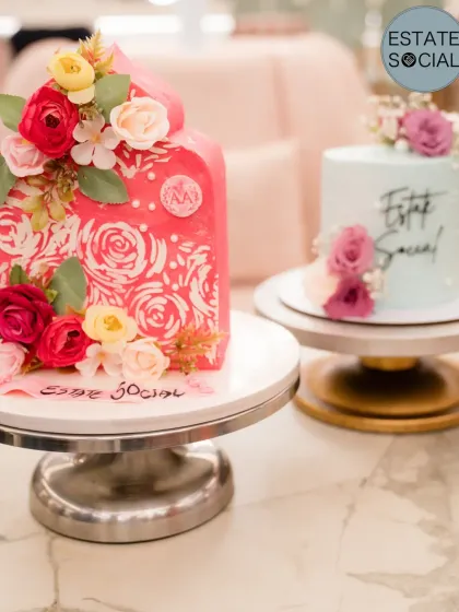 My pastel blue cake next to another stunning floral cake at the women's day celebration.