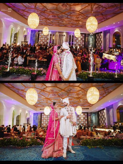 A stunning wide-angle shot of the couple on stage after their Varmala. The grand venue, lighting, and sparklers all contribute to a picture of a truly big fat Indian wedding.