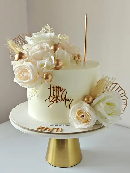White and gold is a timeless combination. This minimalistic cake is adorned with soft, delicate white roses and elegant golden spheres for a truly gorgeous birthday celebration.