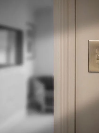 A Rako keypad installed discreetly near a doorway, demonstrating how our control solutions can blend into the background while providing powerful, centralized control for the entire space.