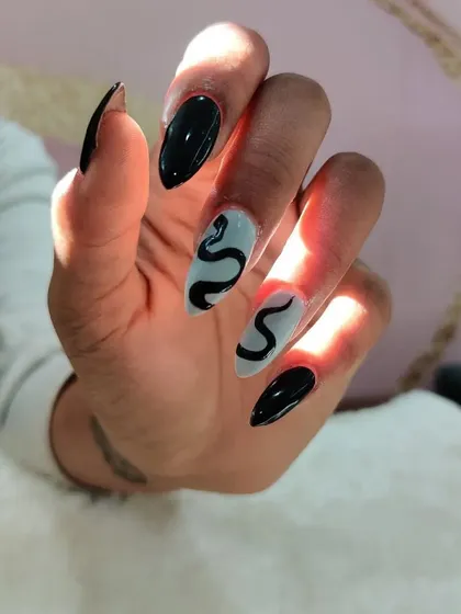 A close-up of the snake design, showing the clean lines and sharp look of the stiletto nails.