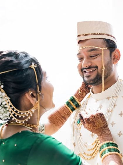 A bride playfully touches her groom's cheek in this light-filled, happy photo.