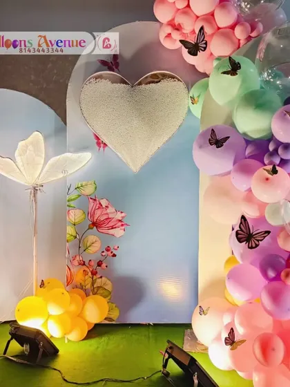 A close-up of the heart detail and floral accents on the butterfly garden backdrop.