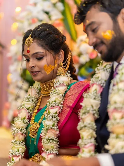 A candid moment from the wedding ceremony. This image captures the intricate details of the temple choker and long necklace during the rituals, showing how our jewellery becomes a part of your most cherished memories.