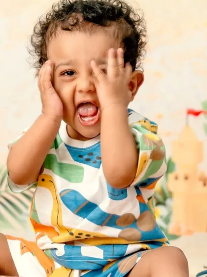 I believe in capturing real personality, not just posed smiles. This playful, candid shot from a beach-themed session is a perfect example of letting a toddler's true, expressive character shine through.