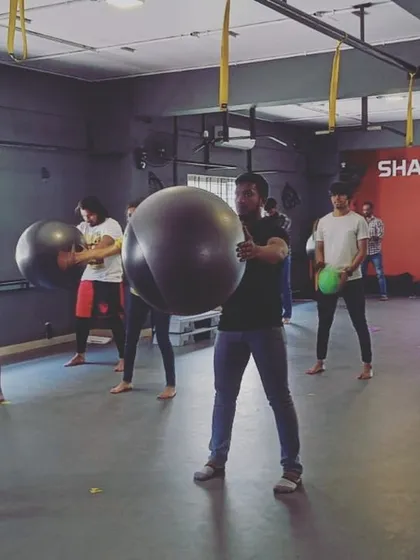 Students in a practical class using stability balls for a dynamic workout, building core strength and coordination.