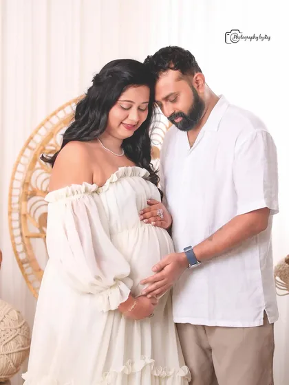 Our studio offers diverse themes, including this cozy bohemian setup. The natural textures of the peacock chair and macrame decor create a warm and inviting atmosphere for this loving couple's maternity portrait.