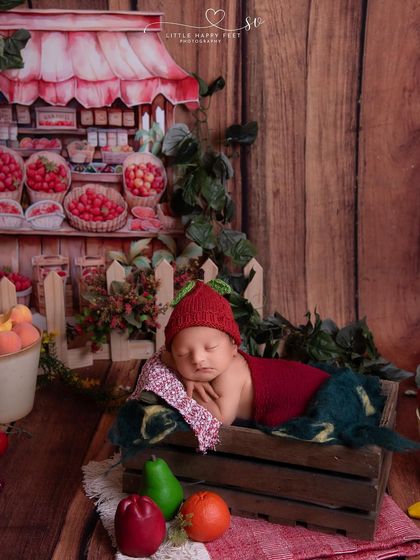 A visit to the fruit stand! This adorable setup features our little one as the sweetest fruit in the market, surrounded by a backdrop of fresh produce.