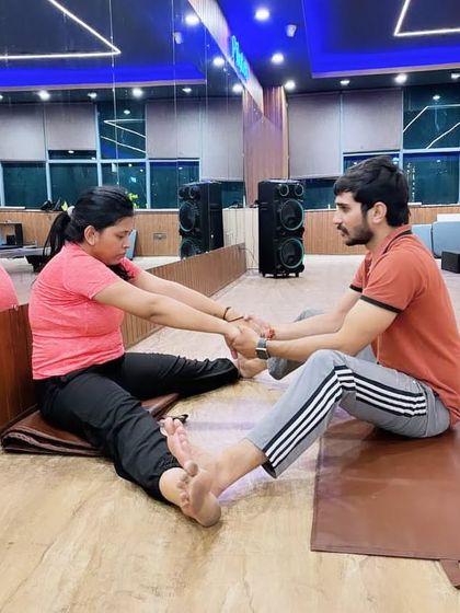 Another example of a partner stretch in a group class, fostering a sense of collaboration and mutual support.