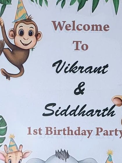 A close-up of the personalized welcome sign for Vikrant and Siddharth's jungle-themed first birthday party, featuring cute cartoon animals.