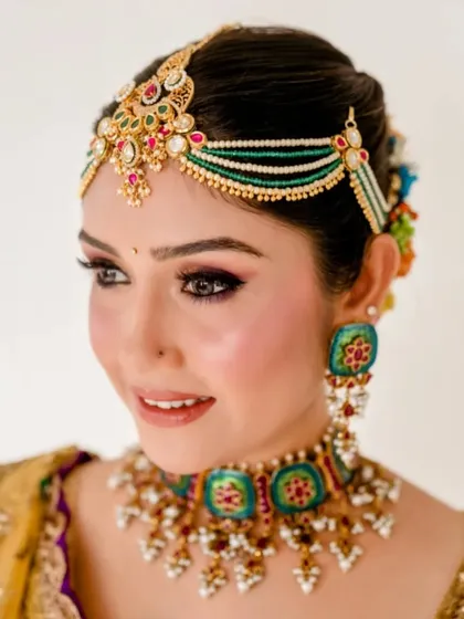 A close-up of the traditional hairstyle, showing the colorful flowers tucked into the bun. This is a beautiful way to add a touch of tradition to any bridal look.