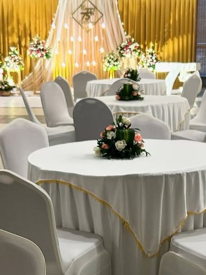 A view of the guest seating arrangement, showing the clean and elegant setup for a formal birthday dinner.