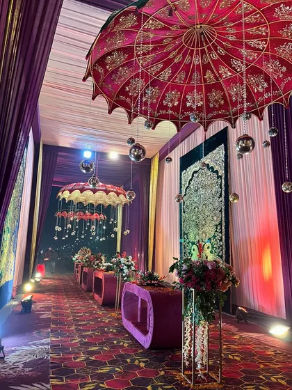 A grand walkway featuring our signature Rajasthani umbrellas and intricate tapestries, creating a rich, layered, and culturally-inspired entrance.