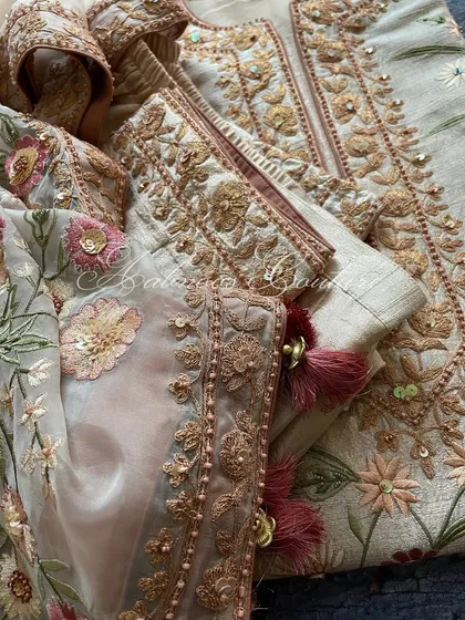 A macro shot of the sleeve cuff, showing the detailed Doriwork and embellishments.