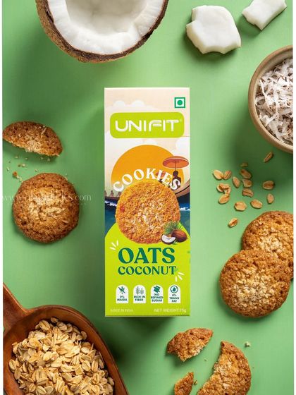 A Unifit oats coconut cookie box, styled with fresh coconut and oats to emphasize its tropical flavor.