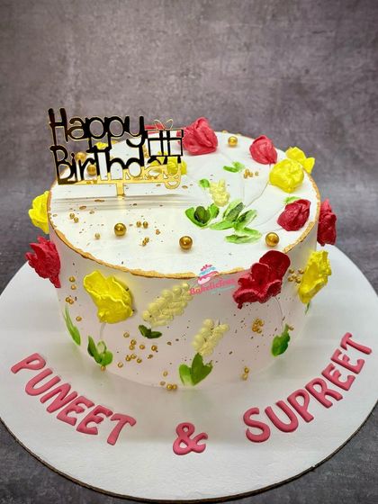 Another example of a trending floral painted cake, this time with red and yellow tulips. This fresh fruit cream cake is as delicious as it is beautiful.