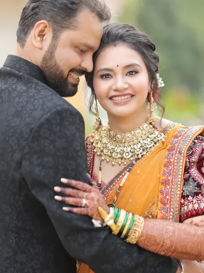 Capturing those quiet, happy moments. This close-up shows her radiant bridal makeup, with a soft focus on glowing skin and eyes that sparkle, creating a timeless memory.
