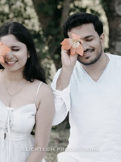 A playful and cute moment in Coorg, with the couple covering their eyes with flowers, capturing their fun and lighthearted connection.