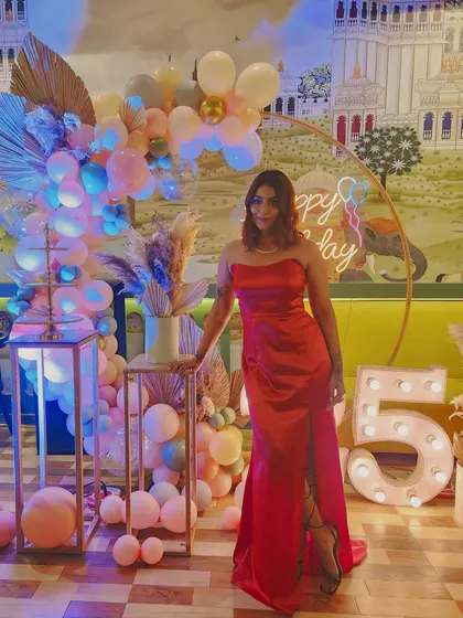 Another full-length shot of the red gown. This custom piece was designed to be both glamorous and comfortable for a night of celebrating.