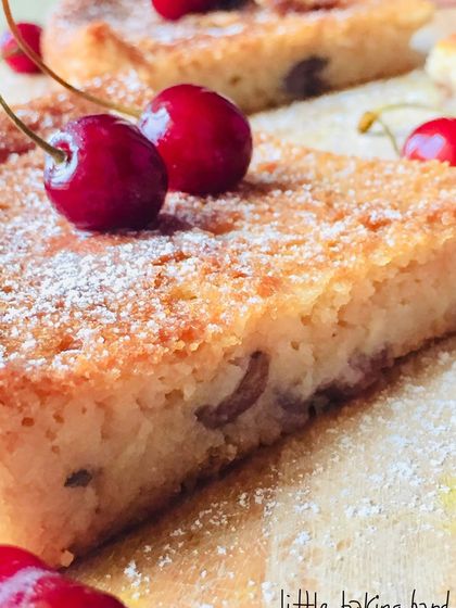 A close-up slice of the vegan vanilla cherry lime cake. You can see the light, tender crumb and pieces of cherry baked inside.