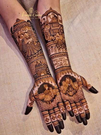 The full view of a heavy bridal mehendi, showcasing a doli scene, a varmala portrait, and other intricate figures that tell the story of a grand wedding.