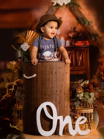 An 'adventure' themed first birthday shoot, with the little explorer ready for his journey from inside a rustic basket.