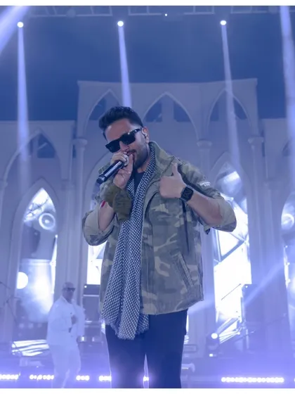 Shekhar Ravjiani captivating the audience. I ensure the stage design, with its grand architectural backdrop and professional lighting, provides a world-class setting for celebrity performances.