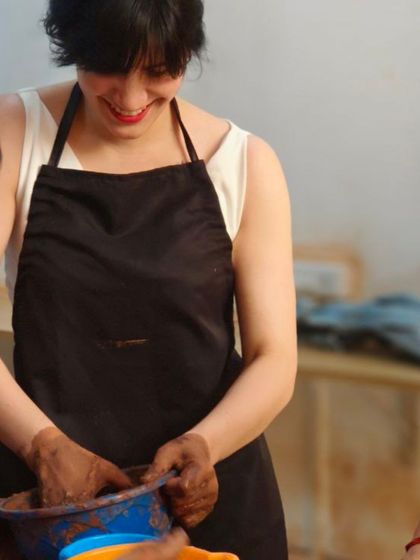 A student learns the first step of pottery: preparing the clay. We teach the process from the very beginning, ensuring you understand how to work with the material before you start creating.
