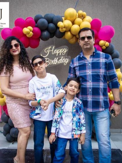 A happy family posing in front of a birthday backdrop I designed. My goal is always to create a beautiful setting for families to make and capture happy memories.