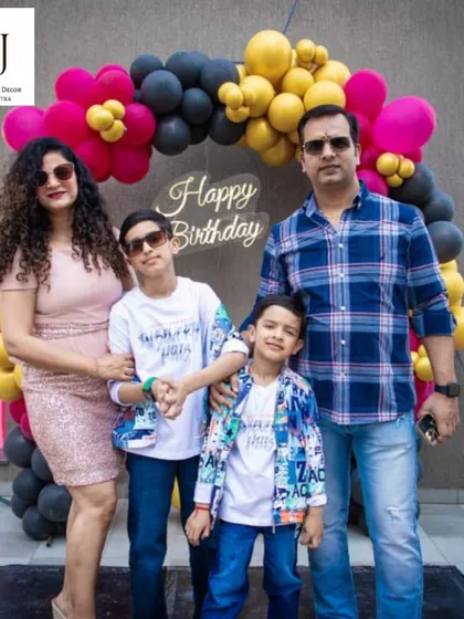 A happy family portrait from a birthday party I planned at Sobha City, Gurgaon. The black, yellow, and pink balloon arch provided a stylish backdrop for their photos.