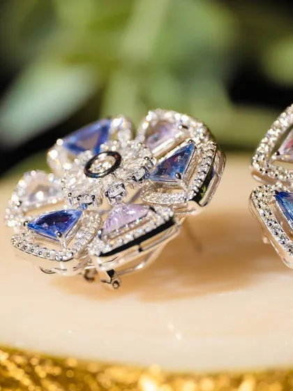 A flower of ice and sky. These unique earrings are crafted with triangular-cut sapphires and diamonds to form a beautiful, geometric bloom. They are a perfect example of how I blend nature's inspiration with modern design.