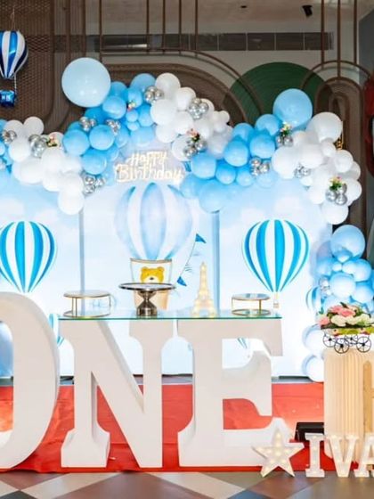 Another beautiful hot air balloon themed first birthday party, featuring a large 'ONE' table and adorable teddy bear props.