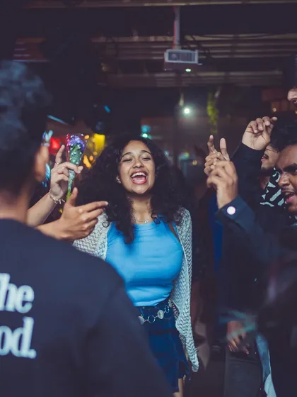 A candid shot of a guest laughing and dancing in the middle of the crowd.