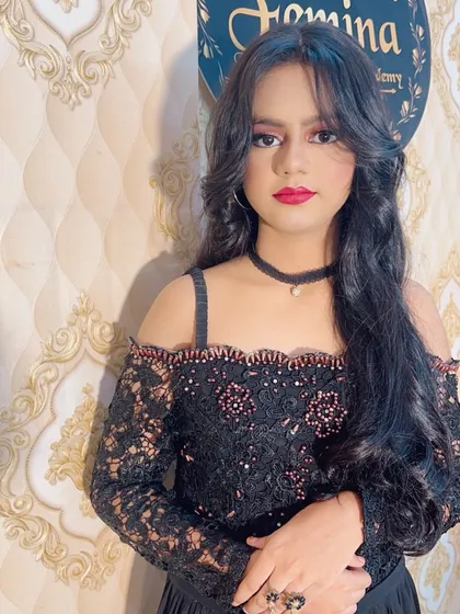 A close-up of the party look, showing the layered hairstyle that frames the face. The makeup is kept elegant with a focus on bold lips and defined eyes.