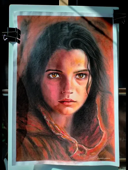 The finished soft pastel artwork on my easel. The warm, earthy tones and the subject's intense gaze make this a very powerful piece.