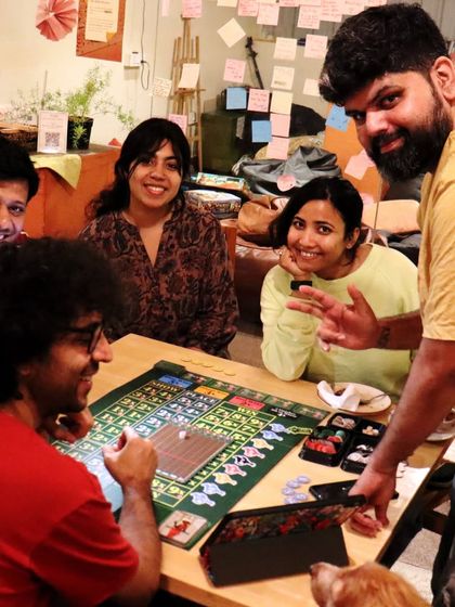 A group enjoys a game of 'Ready Set Bet', complete with a furry friend watching the action. My space is welcoming to everyone, including well-behaved pets.