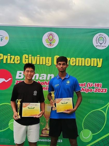 Naishik and his partner at the prize-giving ceremony for the 29th Rajshahi International Junior Championship, where they were crowned doubles champions.