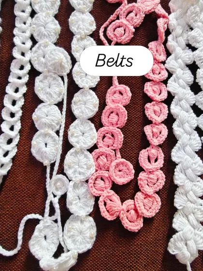 A collection of handmade crochet belts in pink and white. These are delicate, stylish, and perfect for adding a unique touch to a dress or tunic.