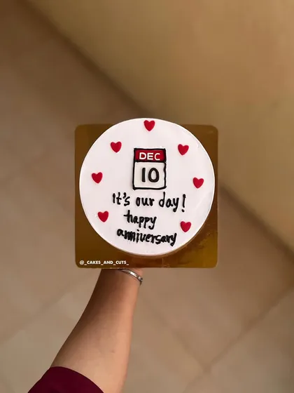 A personalized anniversary cake featuring a calendar marking the special date, "Dec 10."