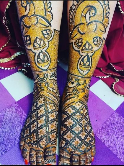 A striking foot design with large, bold peacock motifs highlighted in yellow, creating a vibrant and eye-catching effect.